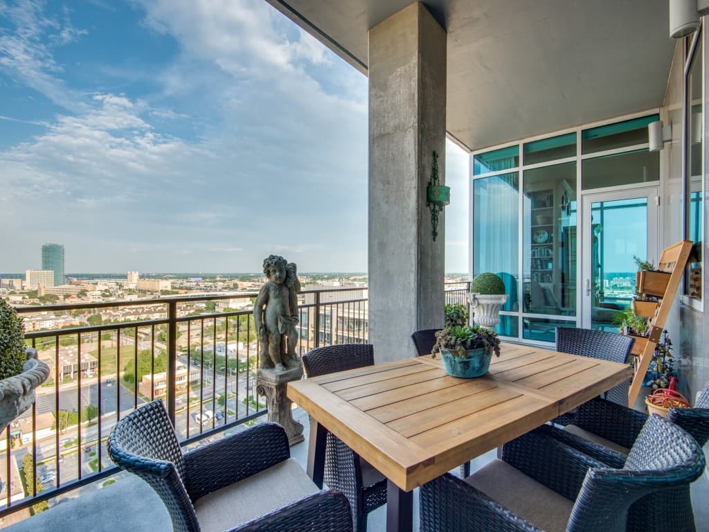Photo of a balcony with chairs and a table in a Trinity Terrace residence.